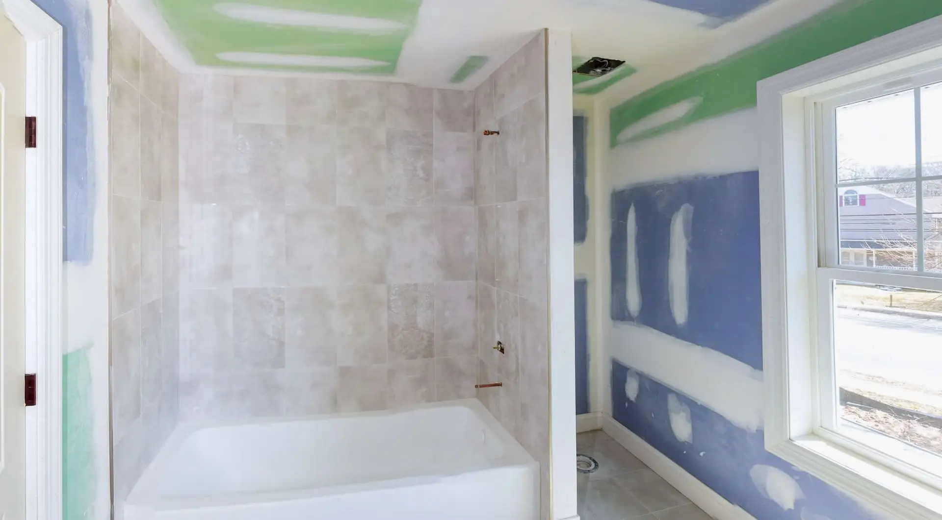 Drywall being smoothed and skim coated after wallpaper removal