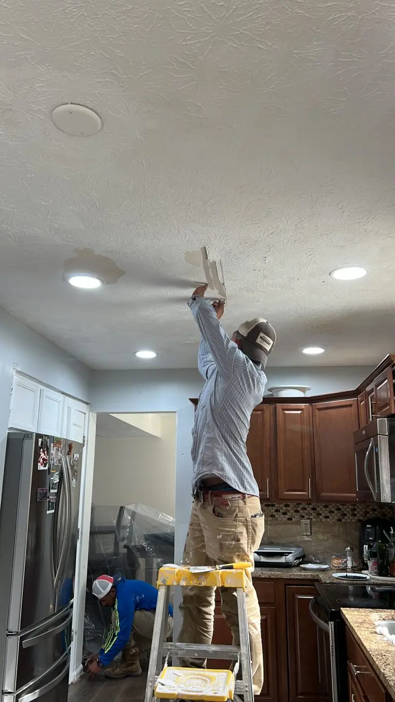 Painter scraping a textured ceiling during popcorn ceiling removal in an Indianapolis kitchen