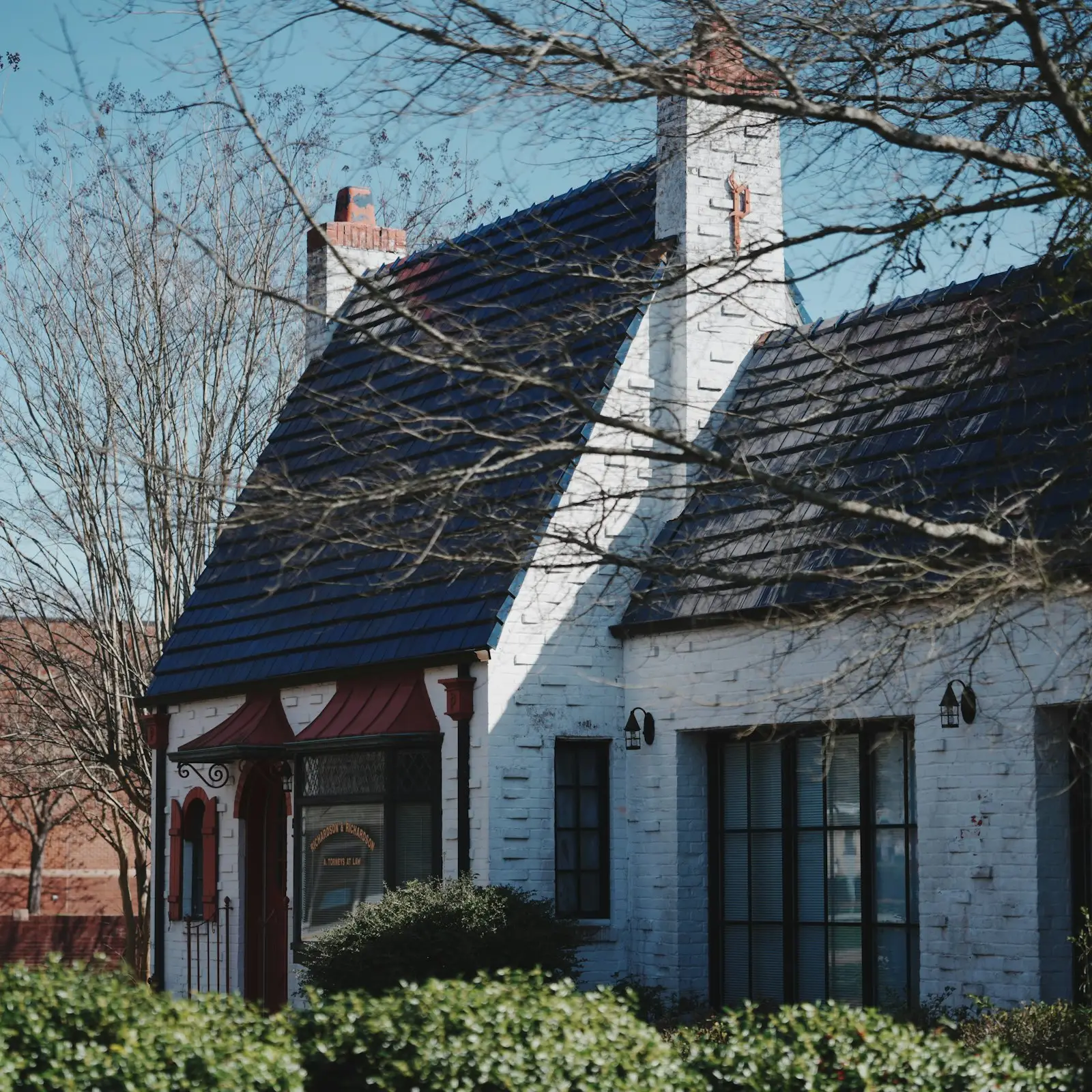 Whitewashed brick storybook cottage exterior — soft lime finish